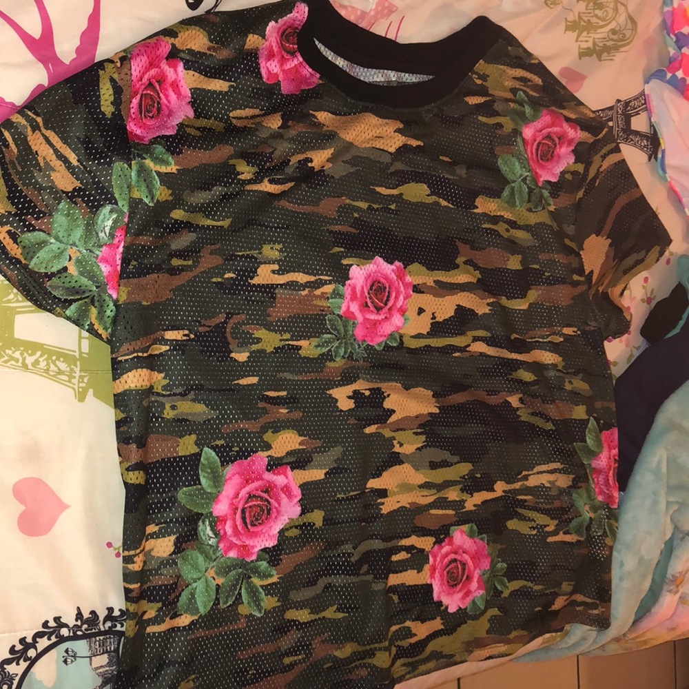 Camouflaged shirt with roses printed on it